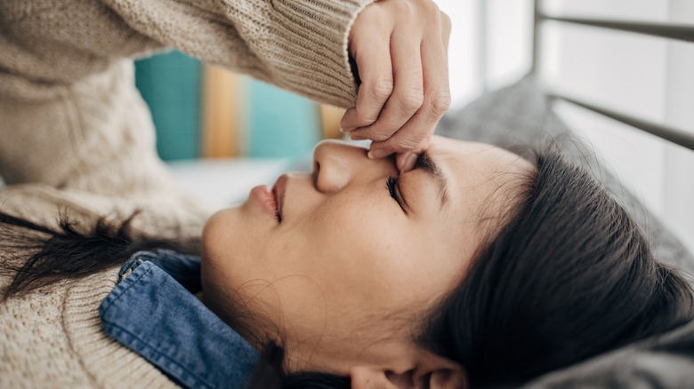 Woman pinching eyebrow