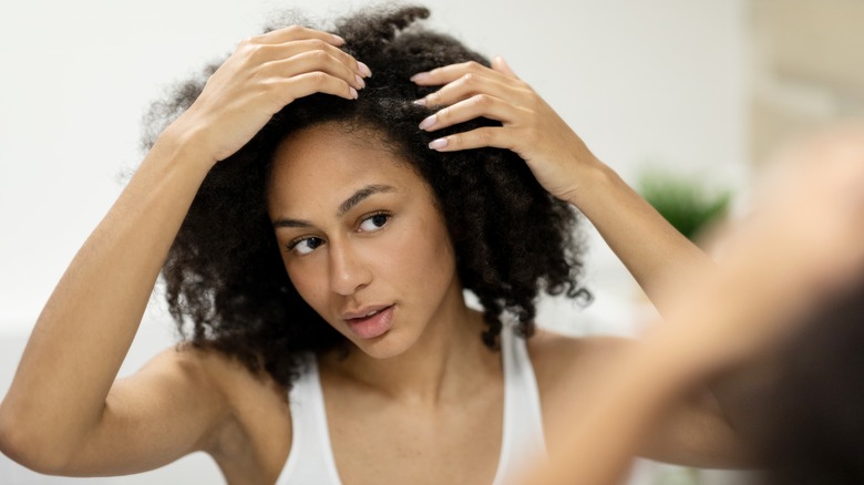 Woman examining hair