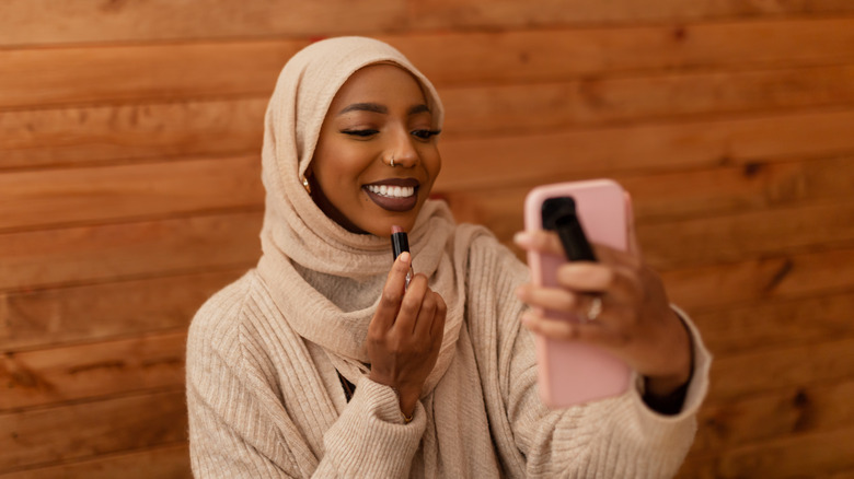 Muslim woman with makeup brush