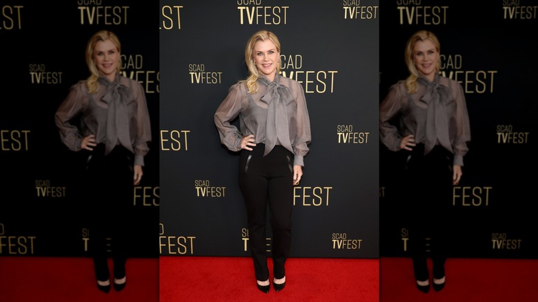 Alison Sweeney on the red carpet wearing a bow top and black pants