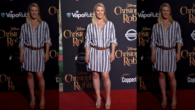 Alison Sweeney on the red carpet wearing knee-length striped ress