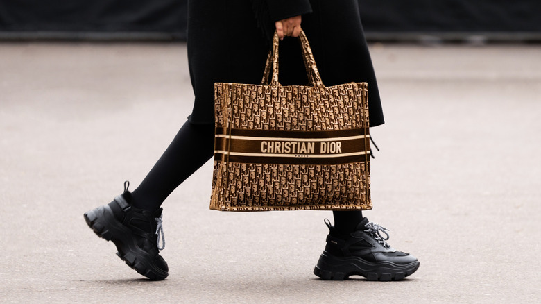 Woman carrying a Dior tote