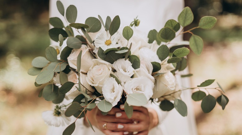 Woman holding flower arrangement