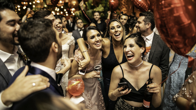 Wedding guests laughing and dancing
