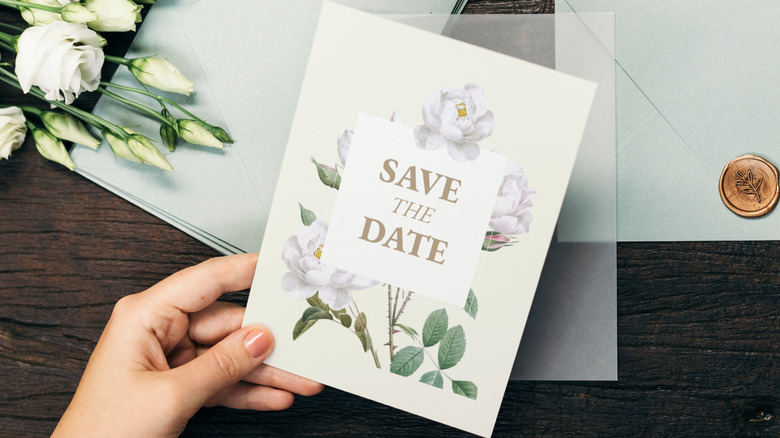 Woman holding wedding invite