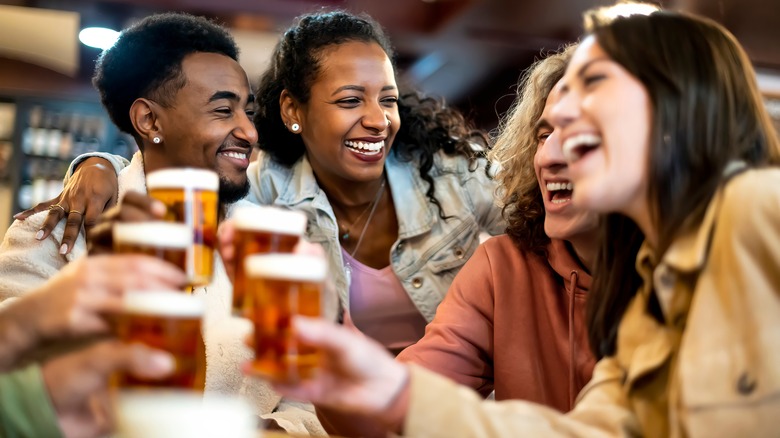 Group of friends toasting at the bar
