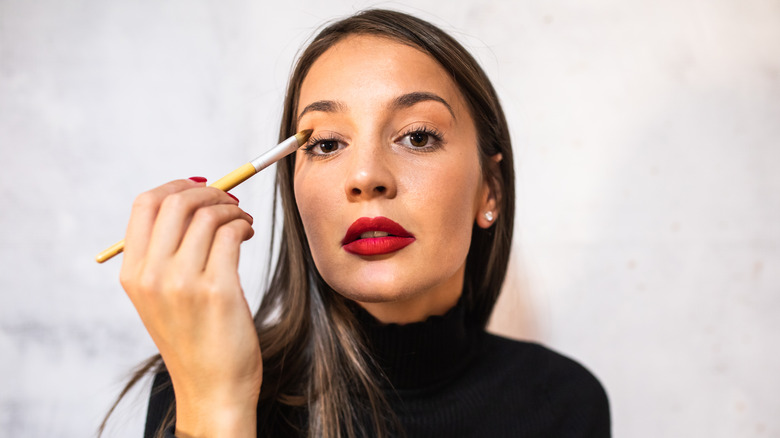 Woman applying eyeshadow
