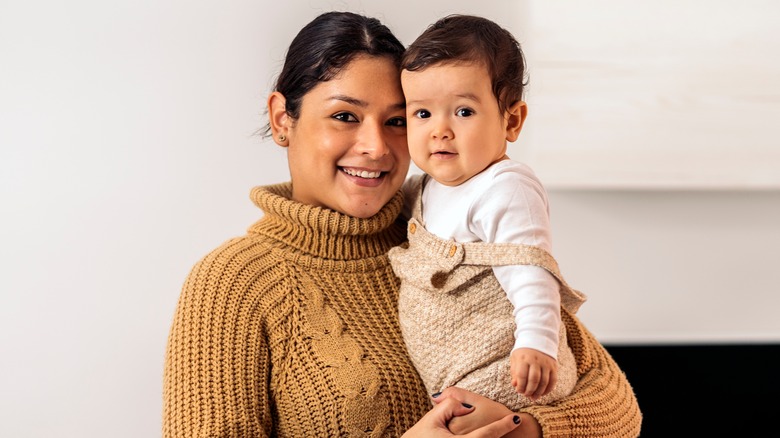 Woman posing with a baby
