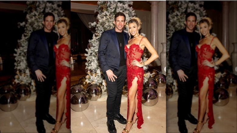 Heather El Mousssa posing with husband while wearing a red dress