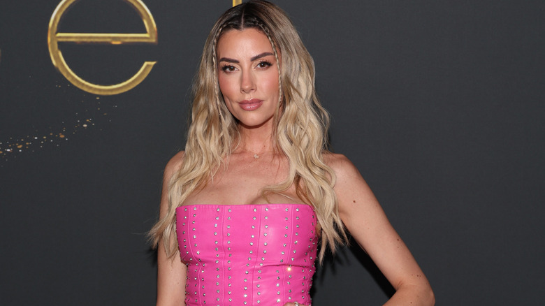 Heather Rae El Moussa in a pink strapless dress at an event