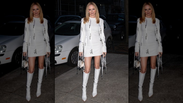 Heather Graham pictured in New York City wearing a white minidress and matching boots