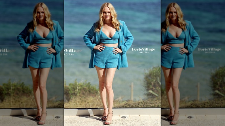 Heather Graham wearing a bikini-style top and shorts in an all-blue outfit at a Filming Italy 2025 photocall