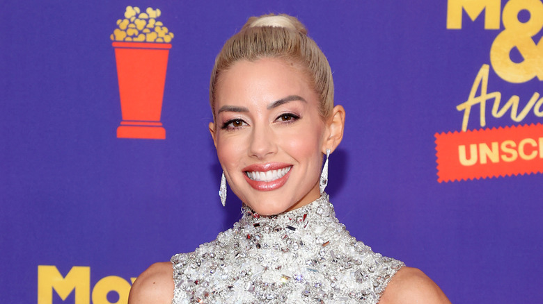 Heather Rae El Moussa in a gem-covered dress on a red carpet