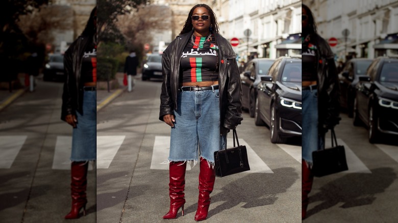 A woman in pointed toe red boots and a denim shorts