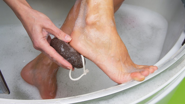 Rubbing pumice on heel