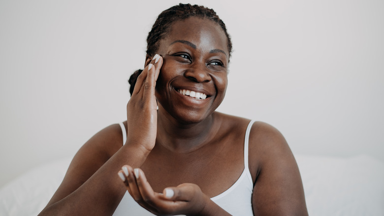 Applying face moisturizer