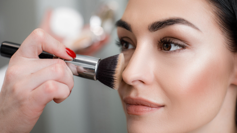 woman applying powder