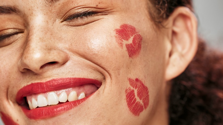 Woman covered in lipstick kisses
