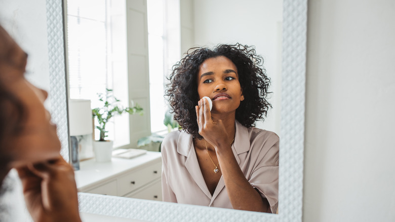 woman applies cream 