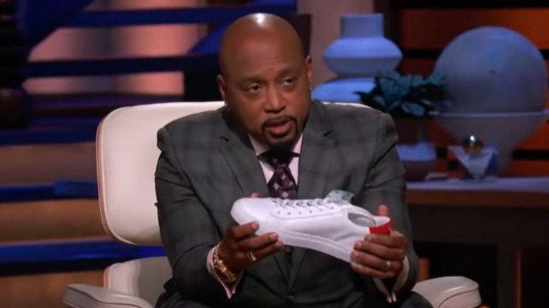 Daymond John with a 1587 Sneakers shoe