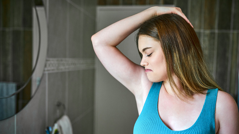Woman smelling her underarms
