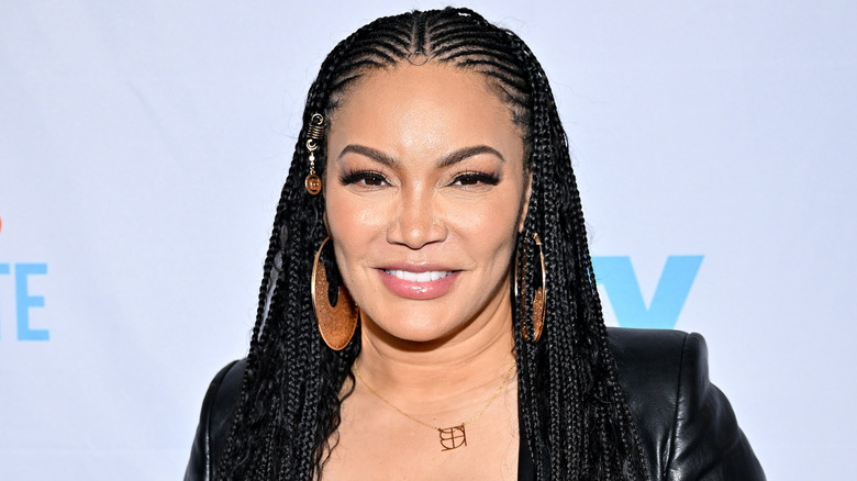 Egypt Sherrod smiles wearing gold earrings
