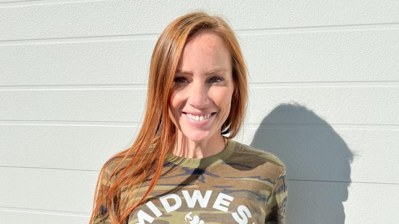 Mina Starsiak Hawk smiles in camoflage t-shirt