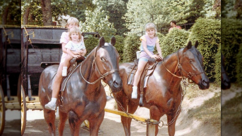 Young Jenny Marrs and two young relatives sitting atop faux horses