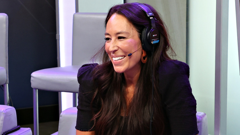 Joanna Gaines smiling with a microphone headset during an interview
