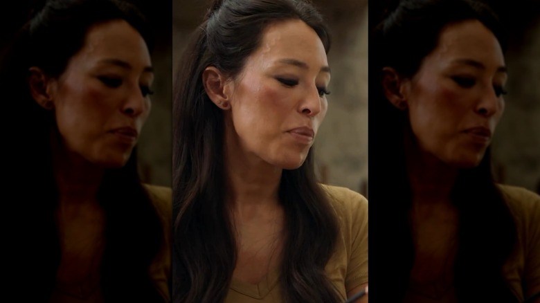 Verticle still of Joanna Gaines on "Magnolia Table" with her V-shaped neckline showing a patchy fake tan