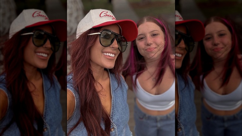 Chelsea DeBoer in a denim vest and a ball cap posing with her daughter