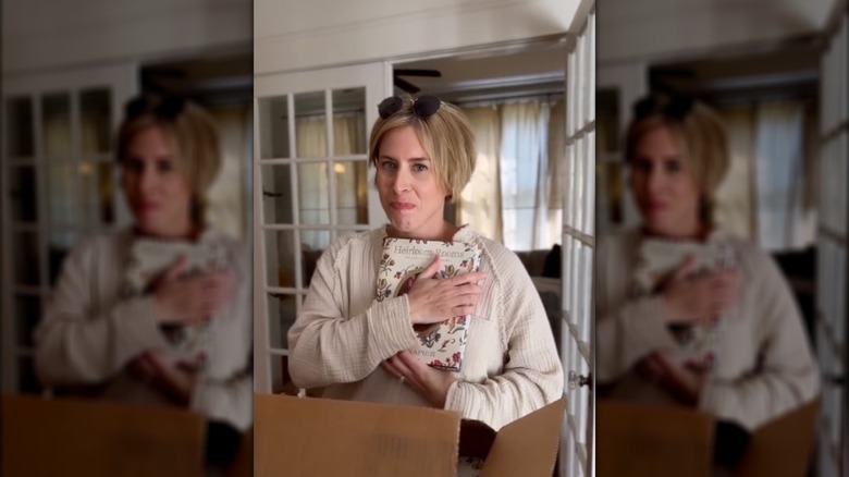 Erin Napier holding her book, "Heirloom Rooms: Soulful Stories of Home"