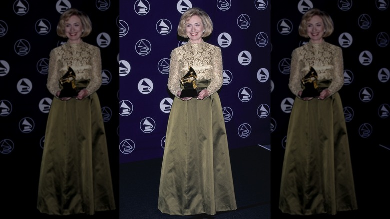 Hillary Clinton holding a grammy for received in the Best Spoken Word or Non-Musical Album category in 1997
