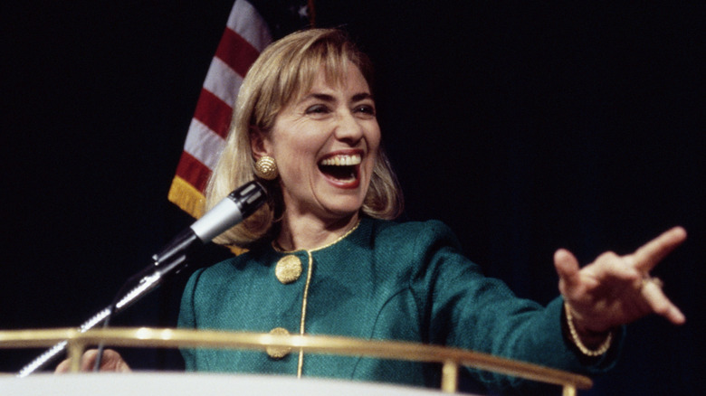 Hillary Clinton in the 1990s in a teal suit jacket