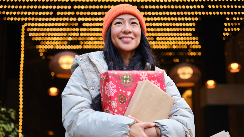 Woman carrying wrapped presents