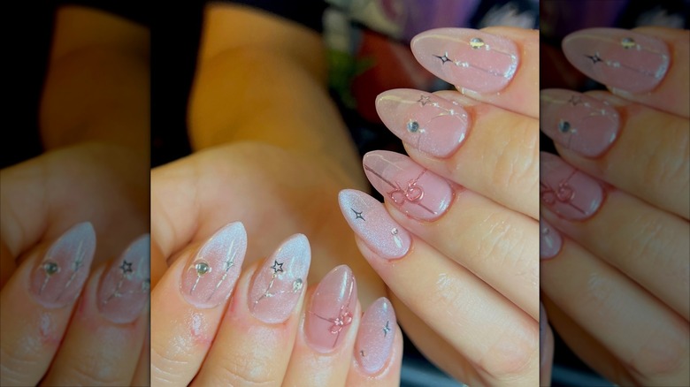 A person with sheer, pink Holiday nails
