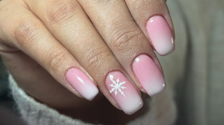 Pink and white ombre nails with a snowflake