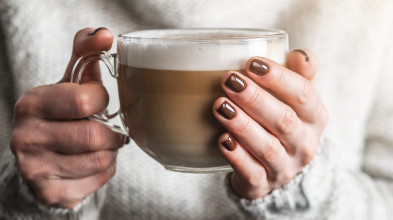Hands sporting hot-chocolate manicure
