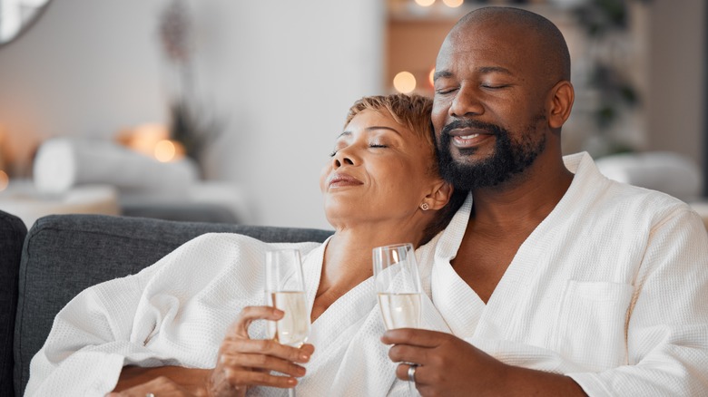 Couple sharing wine in spa robes