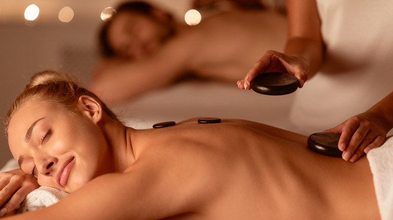 Couple enjoying hot stone massage