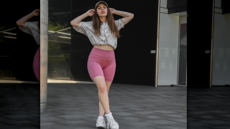 Woman with hat, pink shorts
