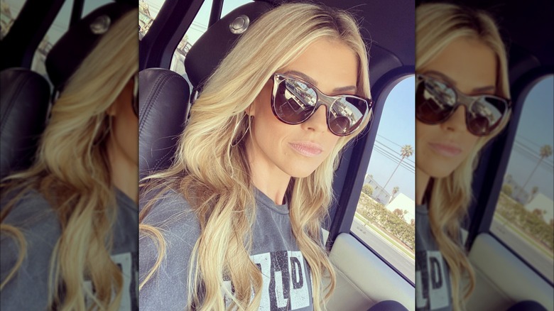 Christina Haack in the car with sunglasses on taking a selfie