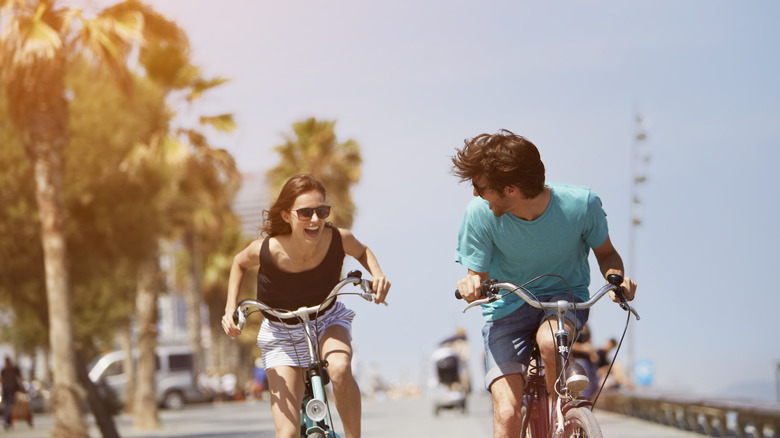 Couple biking together outdoors