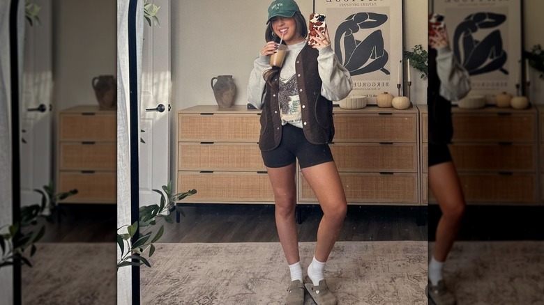 A woman takes a mirror selfie of her outfit