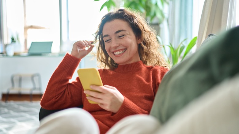 Smiling at phone