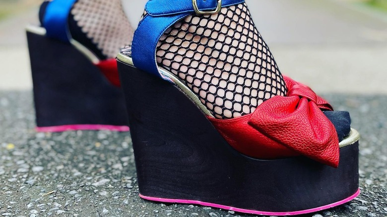 Feet with fishnets and colorful sandals