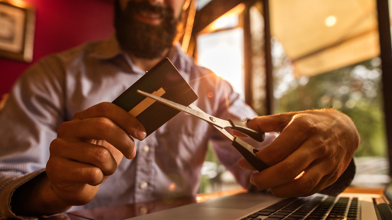 Person cutting up credit card
