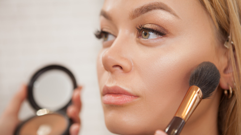 woman with highlighter brush