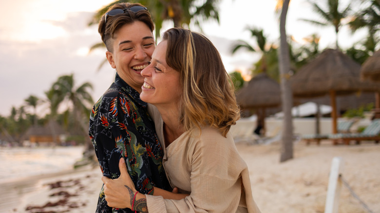 two women hugging smiling