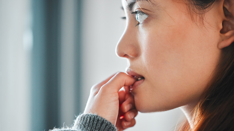 Woman biting nails